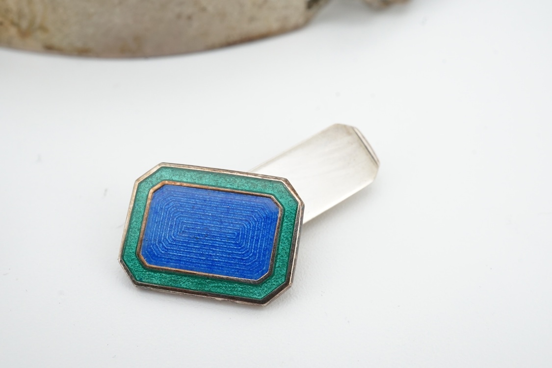 A 1970's silver identity bracelet and a modern pair of silver and two colour enamel cufflinks.